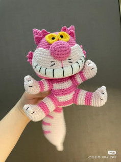 crochet pattern pink cat with yellow eyes.