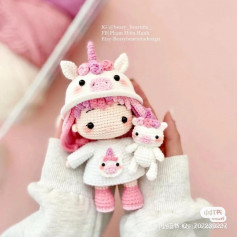 crochet pattern pink haired doll wearing a pig ear hat.