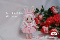crochet pattern white hair doll wearing bunny ears wearing pink dress.