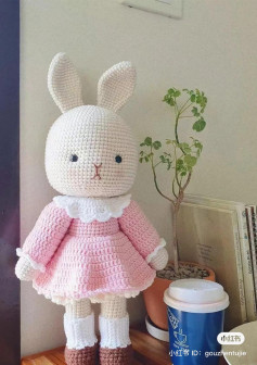 crochet pattern white rabbit long ears wearing pink dress.