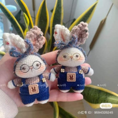 crochet pattern white rabbit wearing blue overalls.