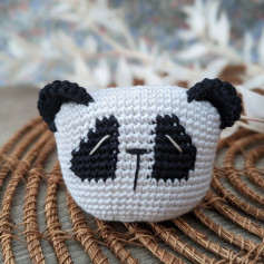 Crochet pattern with panda head, black eyes.