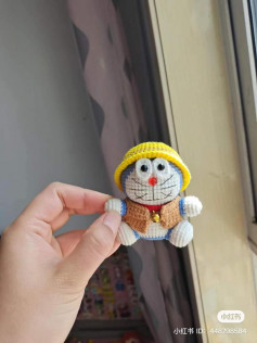 Doraemon crochet pattern with yellow hat.