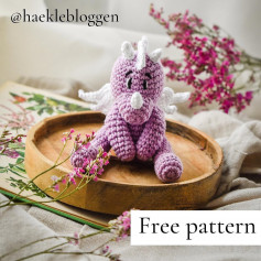 free crochet pattern pink dragon, white horns.