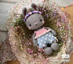 gray rabbit wearing pink crochet pattern dress