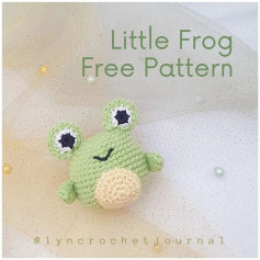 Green frog crochet pattern with bulging eyes, yellow belly.