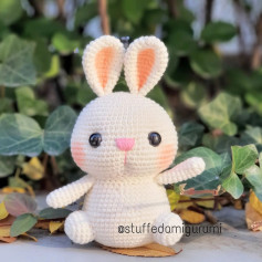 Rabbit crochet pattern with long ears and pink nose.