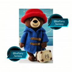 brown bear with white muzzle, red hat, blue shirt with crochet pattern