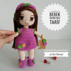 free crochet pattern baby girl doll wearing purple dress, purple braided hair.