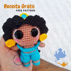 free crochet pattern black-haired doll, wearing blue clothes.