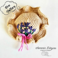 free crochet pattern brown hat with pink bow.