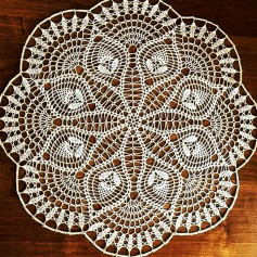 free crochet pattern circle with circles on the edges, leaves on the inside.