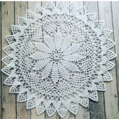 free crochet pattern circular with twelve leaves in the center and spikes at the edges.