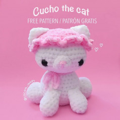 free crochet pattern cucho the cat wears a pink hat with a pink bow tie.