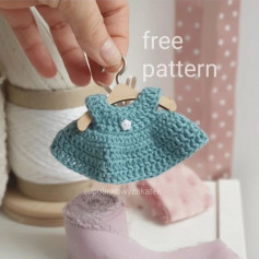 free crochet pattern doll dress with buttons in the middle.