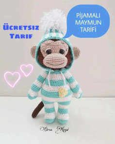 free crochet pattern monkey wearing white and blue striped hat.