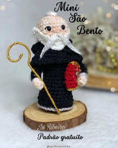 free crochet pattern white bearded saint, wearing black robe.