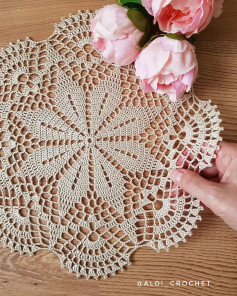 Geometric Crochet pattern in the shape of an eight-petaled flower, with a petal in the center.