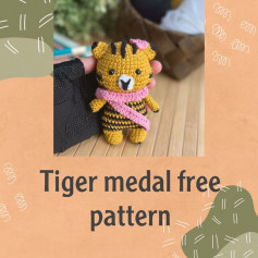 tiger medal free pattern wrapped in pink scarf.