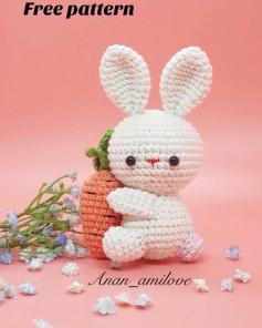 White rabbit holding a carrot