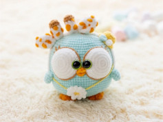 Blue bird crochet pattern with white eyes.