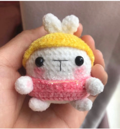 Crochet pattern for a rabbit doll wearing a yellow hat and pink shirt