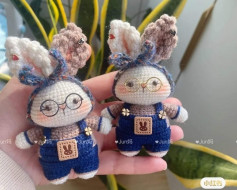 Crochet pattern for a rabbit wearing blue overalls