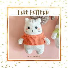 Crochet pattern of white raccoon wearing orange shirt.