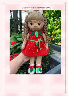 Crocheted doll in strawberry dress.