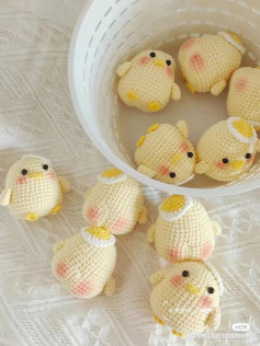 Crochet pattern for a yellow chicken wearing an egg hat with stickers.