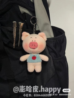 Pink pig keychain crochet pattern, pink nose, wearing blue shirt