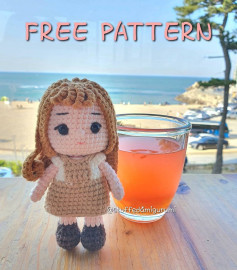 Crochet pattern for a brown-haired doll wearing a dress