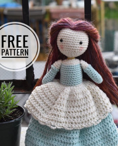 Crochet pattern for a brown-haired doll wearing a moon and blue dress