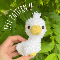 Crochet pattern for a white chicken with a yellow beak.