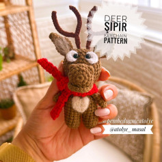 Crochet pattern of a deer wrapped in a red scarf
