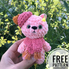 Crochet pattern of a pink bear wearing a hat and a scarf