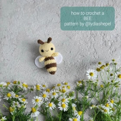 Crochet pattern of bee with white wings and brown stripes
