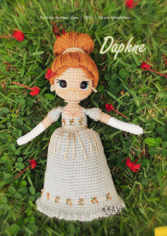 Crochet pattern for a girl doll wearing a gray dress and chestnut hair