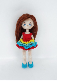 Crochet pattern for a girl doll wearing a rainbow dress