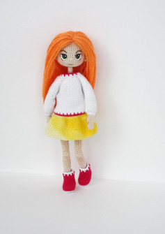 Girl doll crochet model wearing a yellow and white dress and orange hair