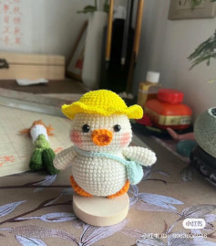 Crochet pattern for a duck wearing a yellow hat and carrying a briefcase