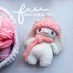Crochet pattern for a white rabbit wearing a hat and pink scarf.
