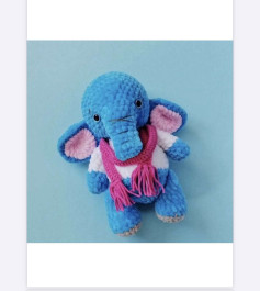 Crochet pattern of blue elephant wrapped in pink scarf.