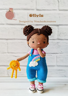 Olivia, Crochet pattern for a girl with her hair in a bun on both sides and wearing overalls