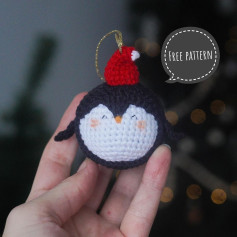 Crochet pattern for a penguin keychain wearing a Christmas hat