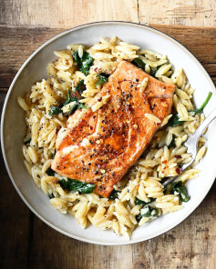 Pan-seared salmon and orzo cooked together with spinach and Parmesan for a complete meal.