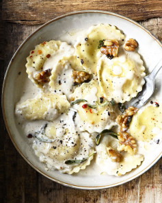 Ravioli in creamy Parmesan sauce, topped with walnuts and crispy sage.