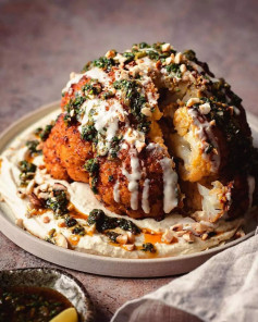 Roasted Cauliflower with Preserved Lemon Chermoula, Tahini Sauce & Crunchy Almonds served on top of Hummus. ❤️