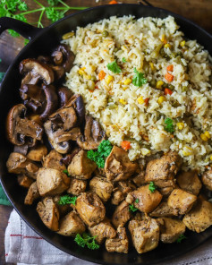 This cast iron skillet chicken breast bites with mushrooms and veggie rice recipe