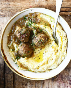 Ricotta Polenta with Drunken Meatballs. Mouthwatering tender meatballs simmered in a hearty brown beer gravy with caramelized onions and served over creamy ricotta polenta. This 30-minute meal will knock your socks off!